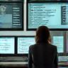 Person calmly handling multiple tasks at a desk, representing workplace stress management.